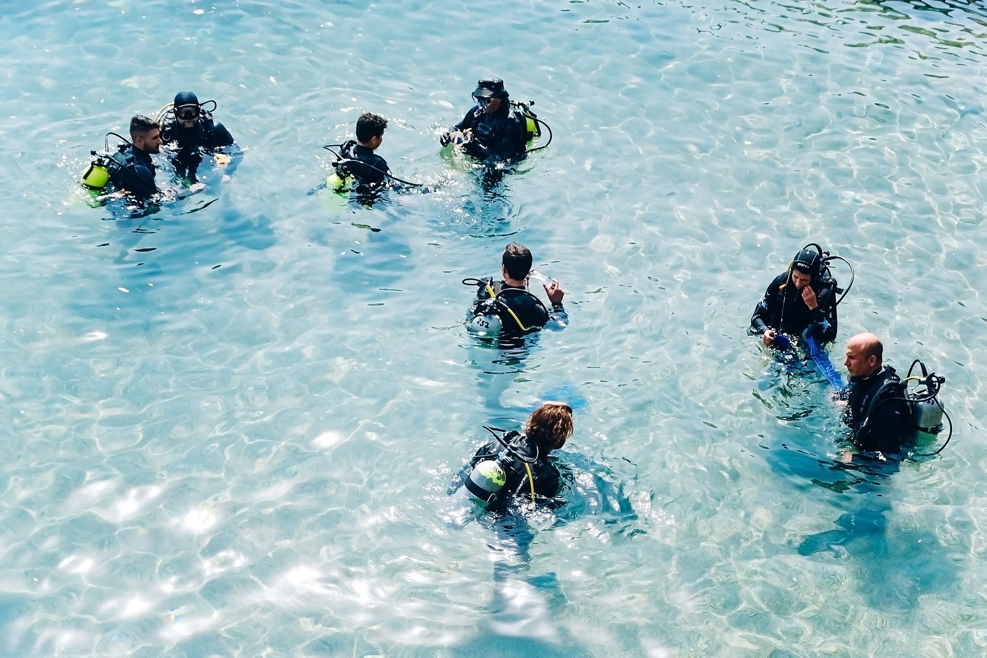Eilat, Israel - 01,16,2021: a group of people in the water getting ready for diving, diving in the red sea in israel Eilat, Israel - 01,16,2021: a group of people in the water getting ready for diving, diving in the red sea in israel